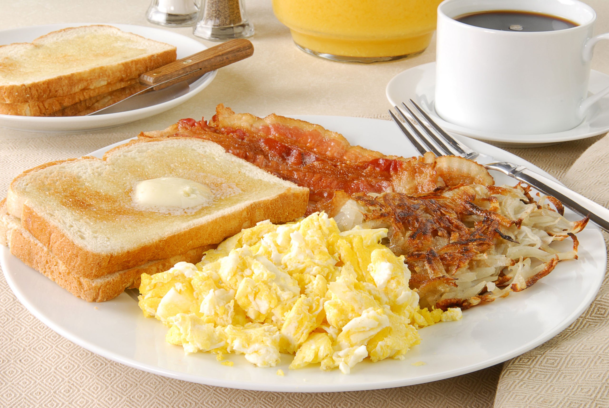 Bacon and eggs with hash browns and an English muffin. - Picture